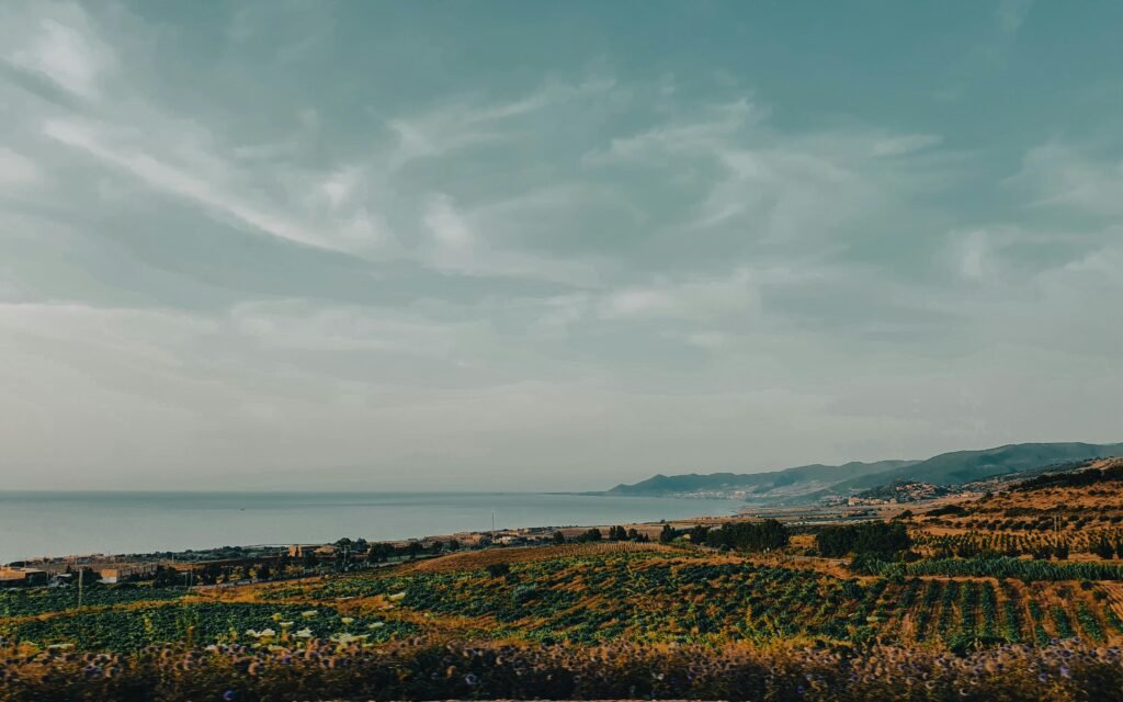 Spectacular view of Ténès' farmland and coastline under a cloudy sky, Chlef Province, Algeria.