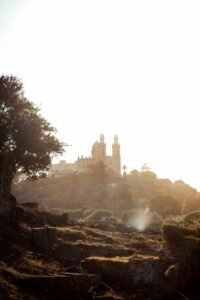 Scenic view of the historic Basilica of St. Augustine amid lush greenery at sunset in Annaba, Algeria.