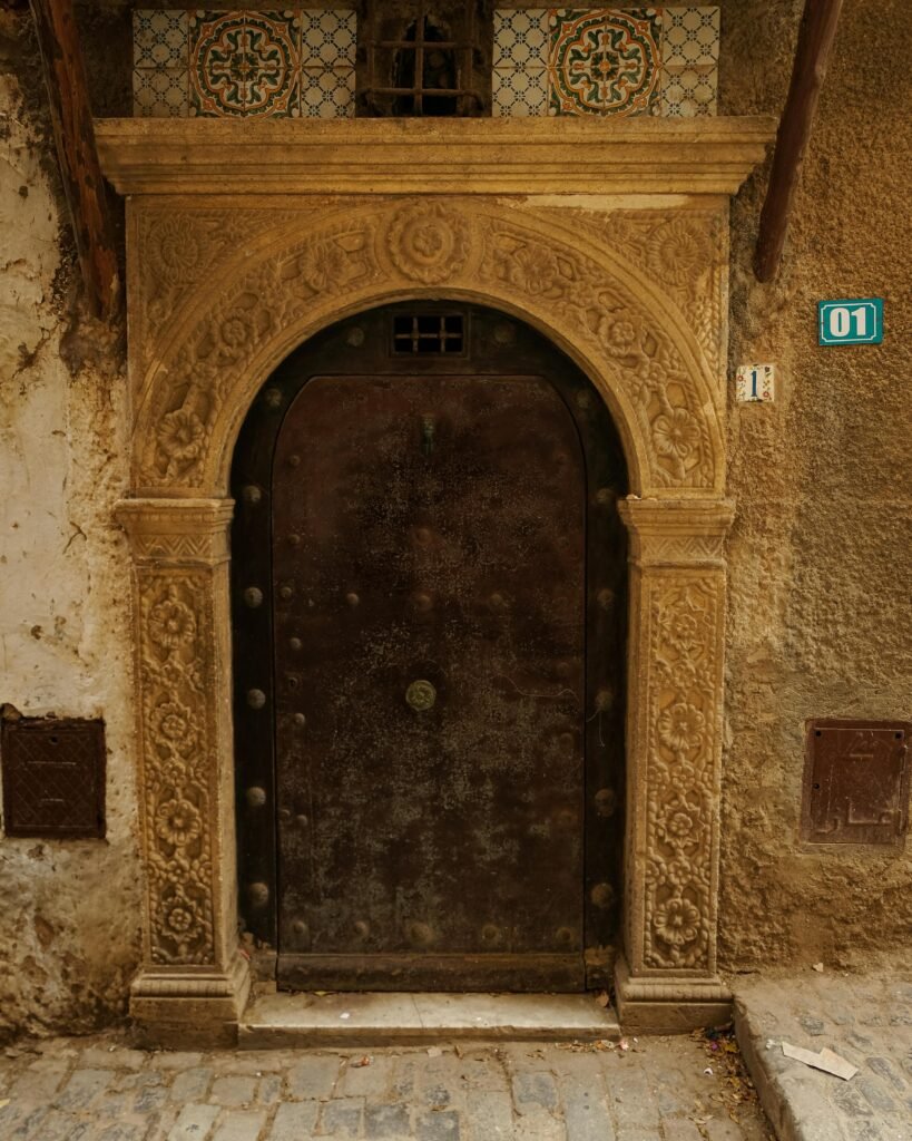Beautiful ornate doorway in the ancient Casbah of Algiers, showcasing intricate craftsmanship.