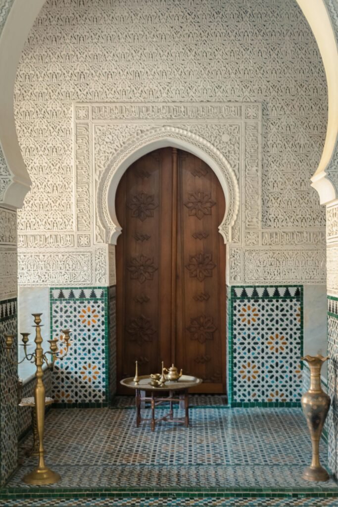 Elegant Arabic architecture featuring carved wooden doors and traditional tile patterns.